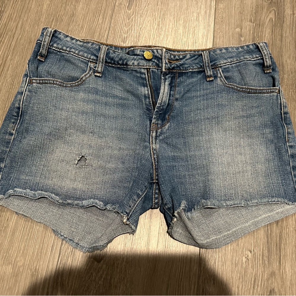 Levi shorts for women, size 8, distressed, frayed bottom.
